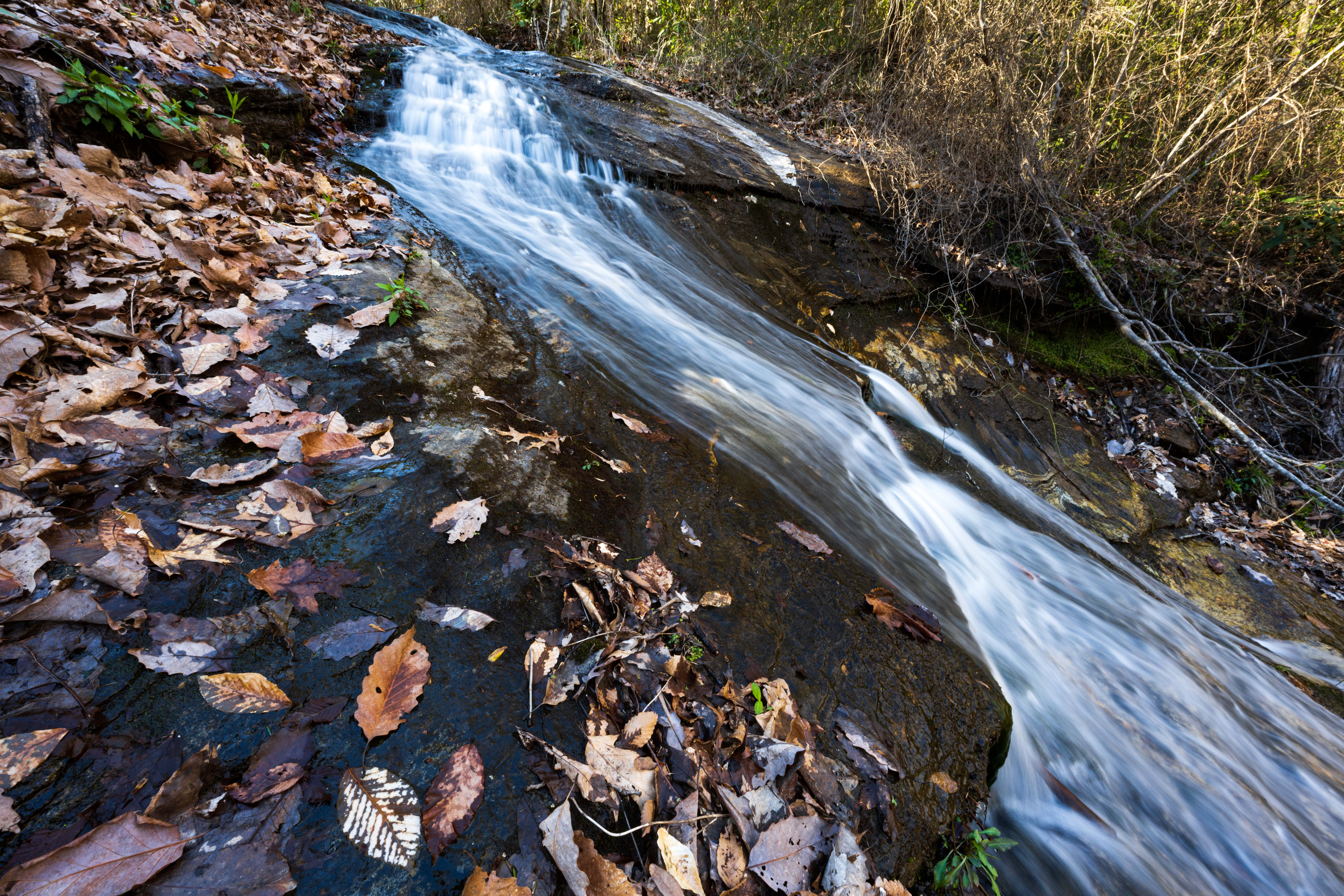 A small waterfall spills down a rockface in the Blue Wall Preserve.